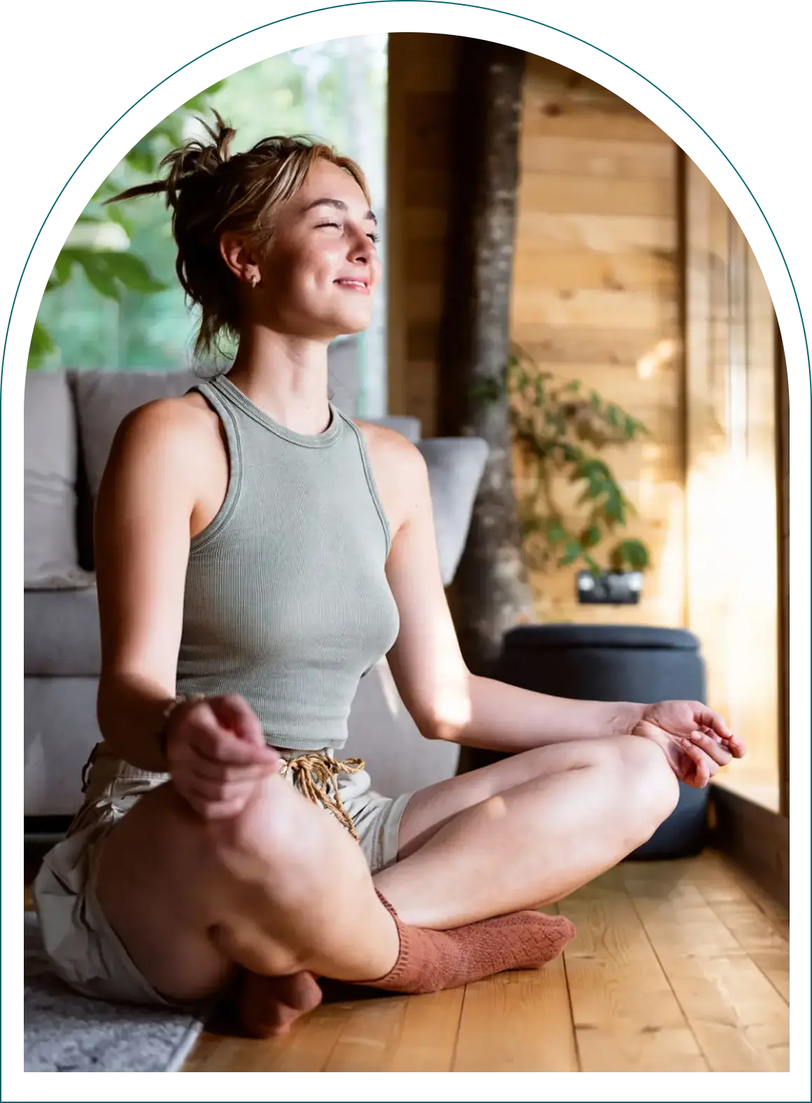 Woman meditating indoors on wooden floor
